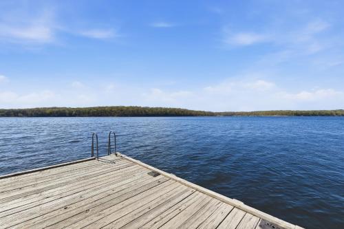 a wooden dock on a large body of water at Quail Cove Oak Premium Lakefront Condo Boat Slip in Shell Knob