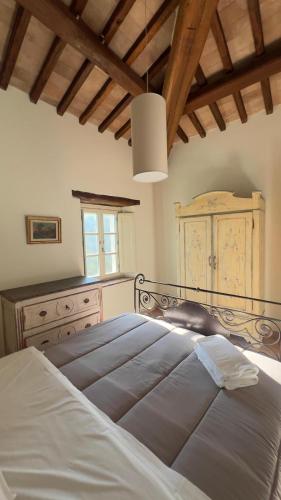 a bedroom with a large white bed and a window at Antico Casale Mevania in Bevagna