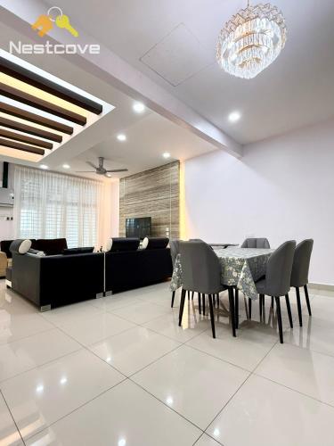 a dining room with a couch and a table and chairs at The Single Level Bliss By Nestcove in Malacca