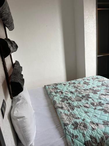 a bedroom with a bed with a pillow on it at Guest house in Imsouane
