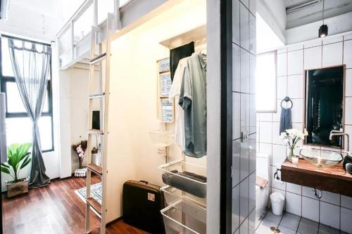 a bathroom with a sink and a mirror at Shade House - Phuket Downtown in Phuket