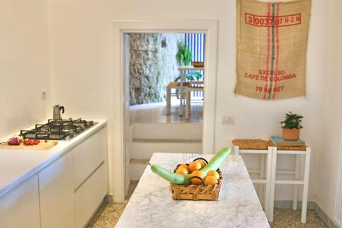 a kitchen with a basket of fruit on a table at Villa Ipomea - Terra Suite in Salerno