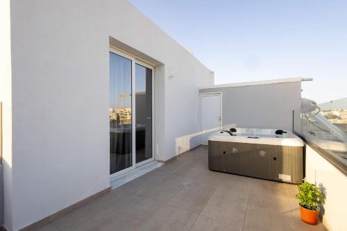 a bathroom with a large window and a bath tub at Sinani Apartment - Sea View Balcony & Jacuzzi Gem in Asgourou