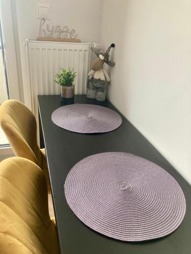 a table with two purple plates on top of it at Apartment Poprad in Poprad