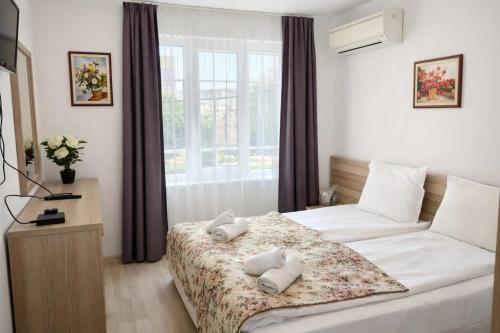 a bedroom with a bed with two pillows on it at Къщата с чешмата in Veliko Tŭrnovo