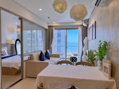 a room with a bed and a couch and a table at Ngân Nguyễn Apartment - The Sóng Vũng Tàu in Vung Tau