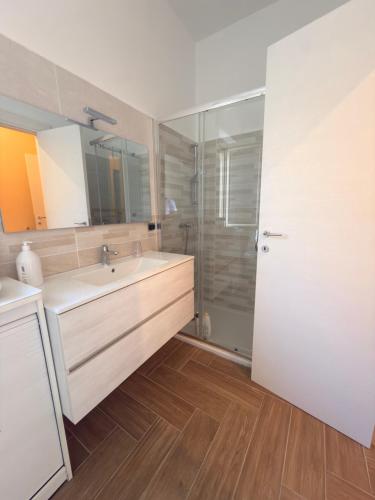 a bathroom with a sink and a glass shower at Il gelso in Bovalino Marina