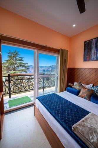 a bedroom with a bed and a large window at Opal Villas Mussoorie near Mall Road in Mussoorie
