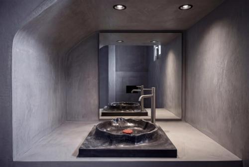 a bathroom with a sink and a mirror at Anzo Villas in Oia