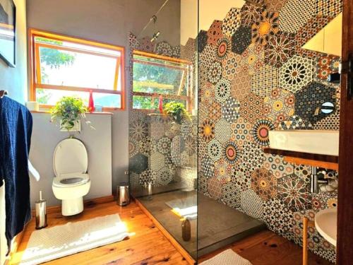 a bathroom with a toilet and a sink and a shower at River Star Retreat in Zuurbraak