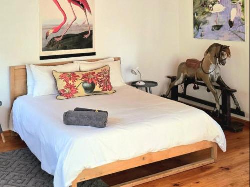 a bedroom with a bed with a horse on a table at River Star Retreat in Zuurbraak