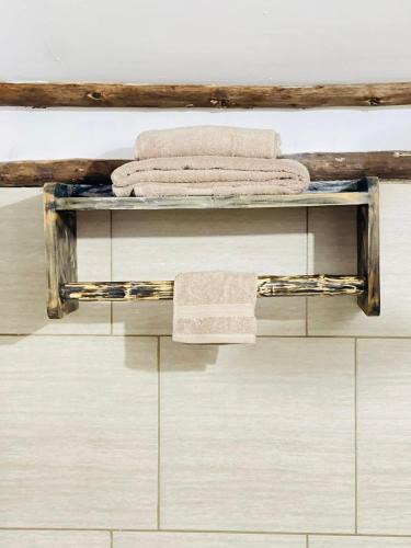 a shelf in a bathroom with towels on it at Kitunduni Lodge in Arusha
