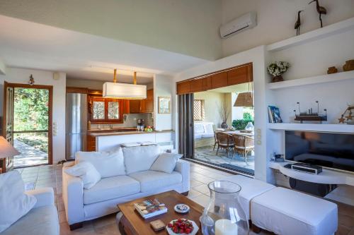 a living room with a couch and a table at Magnolia bliss Calm & Cozy Villa, Sani in Sani Beach