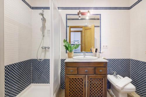 a bathroom with a sink and a toilet and a shower at Matalascañas Primera Línea de Playa in Matalascañas