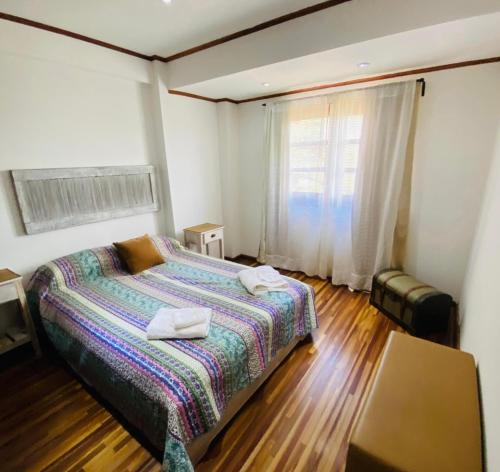 a bedroom with a bed with two towels on it at Arborea in Posadas