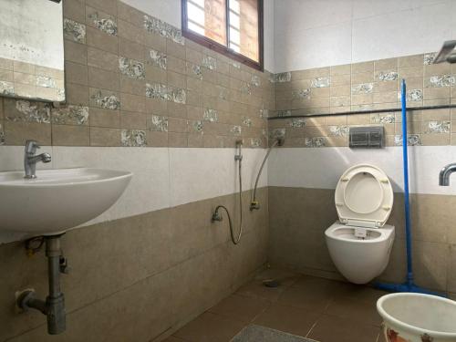 a bathroom with a toilet and a sink at Satgiri Nest House in Chikmagalūr