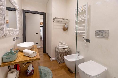 a bathroom with a toilet and a sink and a shower at Piazzetta della Torre in Chiavari