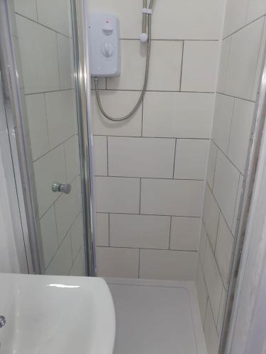a white bathroom with a shower with a toilet at City view place, City Centre in Chesterton