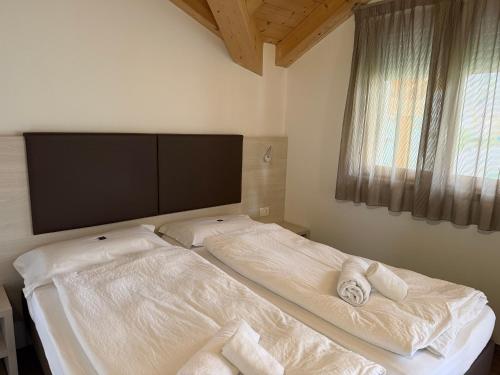 a bedroom with two beds with towels on them at Sugadoi in Predazzo