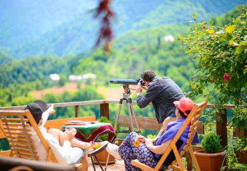 a man taking a picture of a group of people at Guest House Mokvare in Gundauri