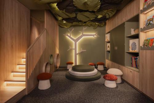 a childrens room with a tree on the wall at Schlosshotel Fiss in Fiss