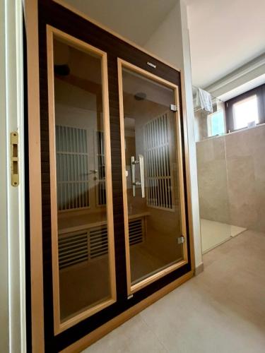 a glass door in a room with a cell at Garda Relais in Castelnuovo del Garda