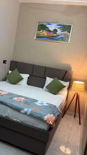 a bedroom with a bed and a picture on the wall at Moon Stays Newly Build I Couple Friendly I Panipat in Pānīpat
