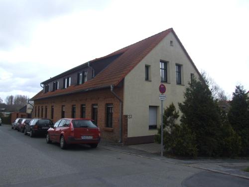 a red car parked in front of a building at Hostel Vorharz Quedlinburg in Quedlinburg