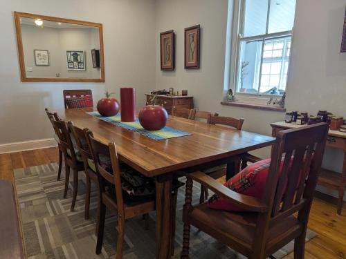 a dining room table with apples on top of it at Mayors Rest on 44 in Uniondale
