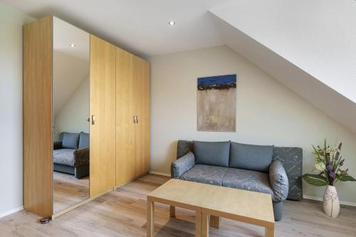 a living room with a couch and a table at Pure Relaxation in Heiligenhafen