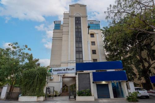 a tall white building with a clock tower at Treebo GT Meridian, T-Nagar in Chennai
