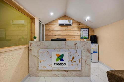 a lobby with a trico sign on a wall at Treebo GT Meridian, T-Nagar in Chennai