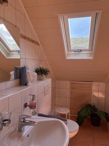 a bathroom with a sink and a window at Weingut Zenz-Pohl in Kinheim