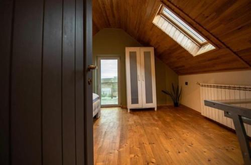 an empty room with a skylight in a house at Guesthouse340 in Roman