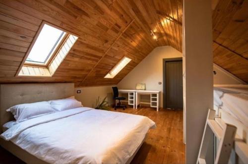 a bedroom with a large white bed in a attic at Guesthouse340 in Roman