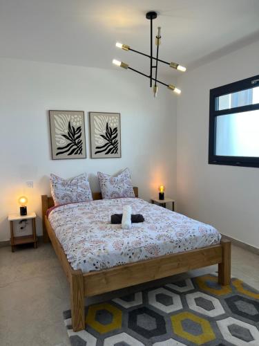 a bedroom with a bed with a teddy bear on it at Les Appartements chez Hanene in Le Grau-du-Roi
