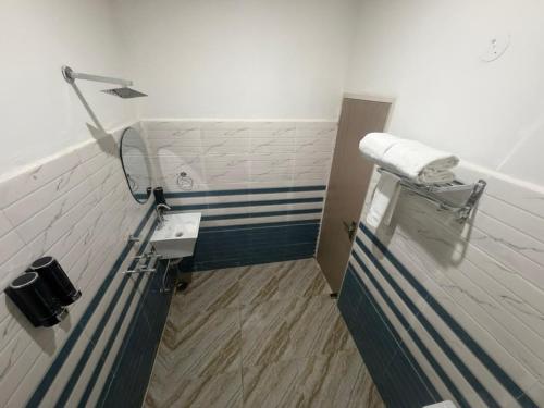 a small bathroom with a sink and a toilet at A One Residency in Bahora