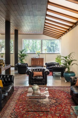 a large living room with couches and a table at Hotel Al Sant'Andrea in Sarzana