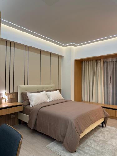 a bedroom with a large bed and a window at Resorts World Eighty One Newport Boulevard Near Airport T2 and T3 in Manila