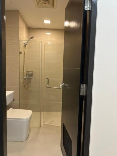 a bathroom with a shower and a toilet and a sink at Resorts World Eighty One Newport Boulevard Near Airport T2 and T3 in Manila