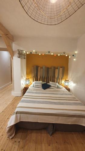 a large bedroom with a large bed in a room at T'nature à Château Chalon in Château-Chalon