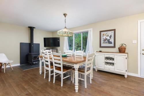 a dining room with a table and chairs at Ideal getaway - Ideal retreat in Lac-Brome