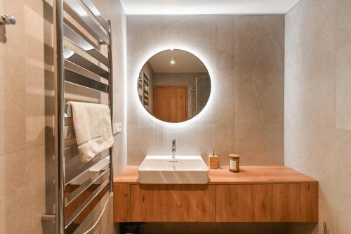 a bathroom with a sink and a mirror at Hotel Monínec - Depandance Apartmány in Moninec