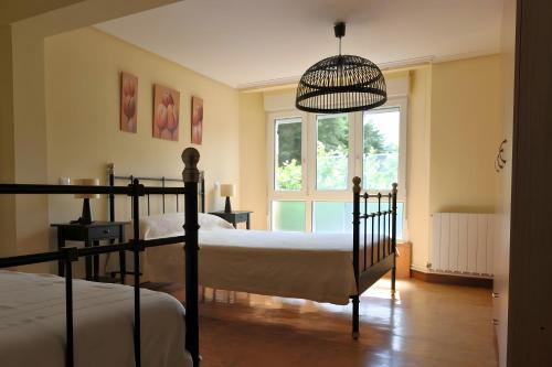 a bedroom with two beds and a window at La Casona de Ilusión in Solórzano