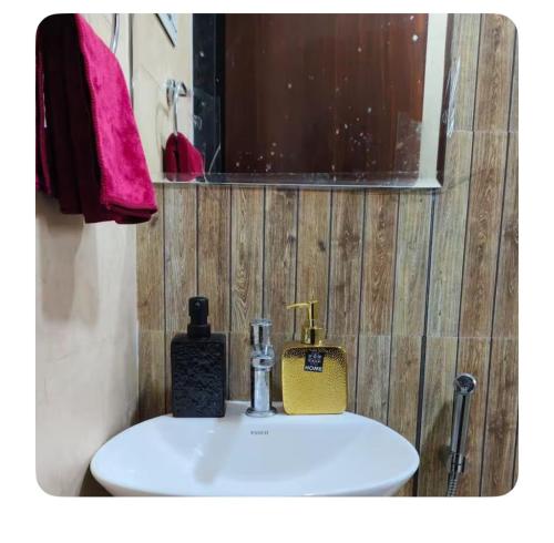 a bathroom sink with a soap dispenser on it at The Aura stays in Indore