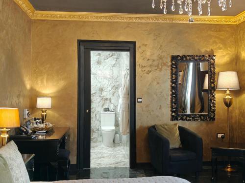 a hotel room with a door leading to a bathroom at Julina Boutique Living in Mosta