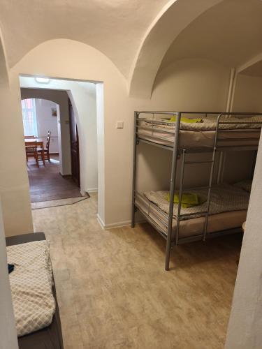 a room with two bunk beds and a hallway at Jüstel apartment in Litoměřice