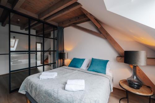 a bedroom with a bed with two towels on it at Farma Mračov in Kadov