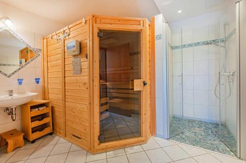 a bathroom with a shower and a toilet and a sink at Ferienwohnung Wassermann in Loddin
