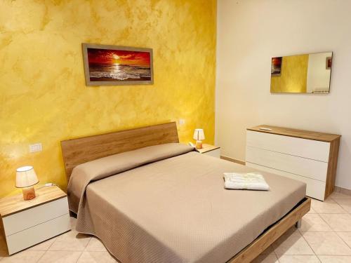 a bedroom with a large bed and two night stands at Fiorucci Apartments - Daniele's House Lago Di Bolsena in Marta